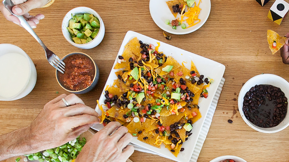 Real Plans People Sharing Nachos on a Wood Table
